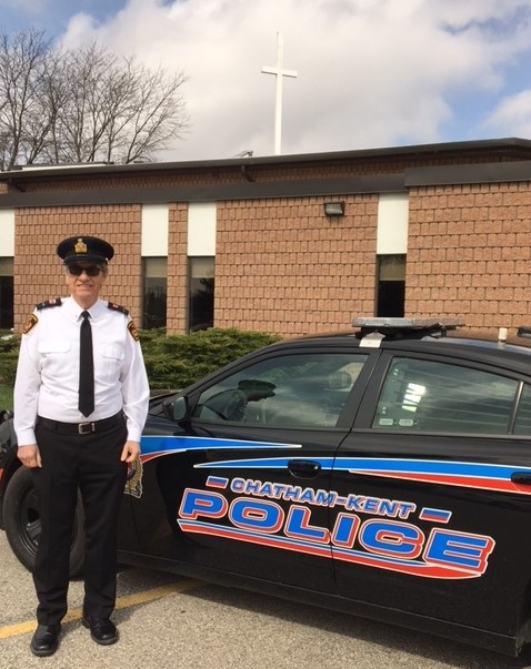 Chaplain with police cruiser